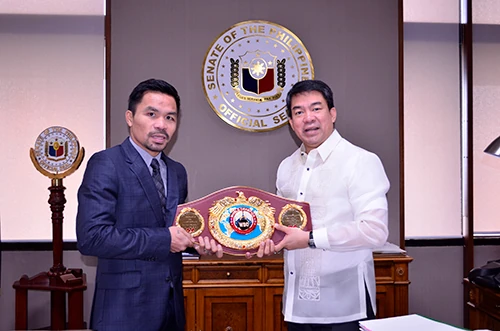 Manny Pacquiao holds the WBO belt with Aquilino Pimentel III